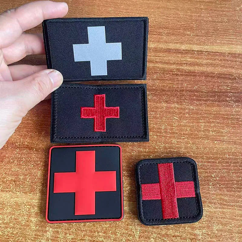 Three tactical morale patches featuring a medical cross symbol in white, red, and black.