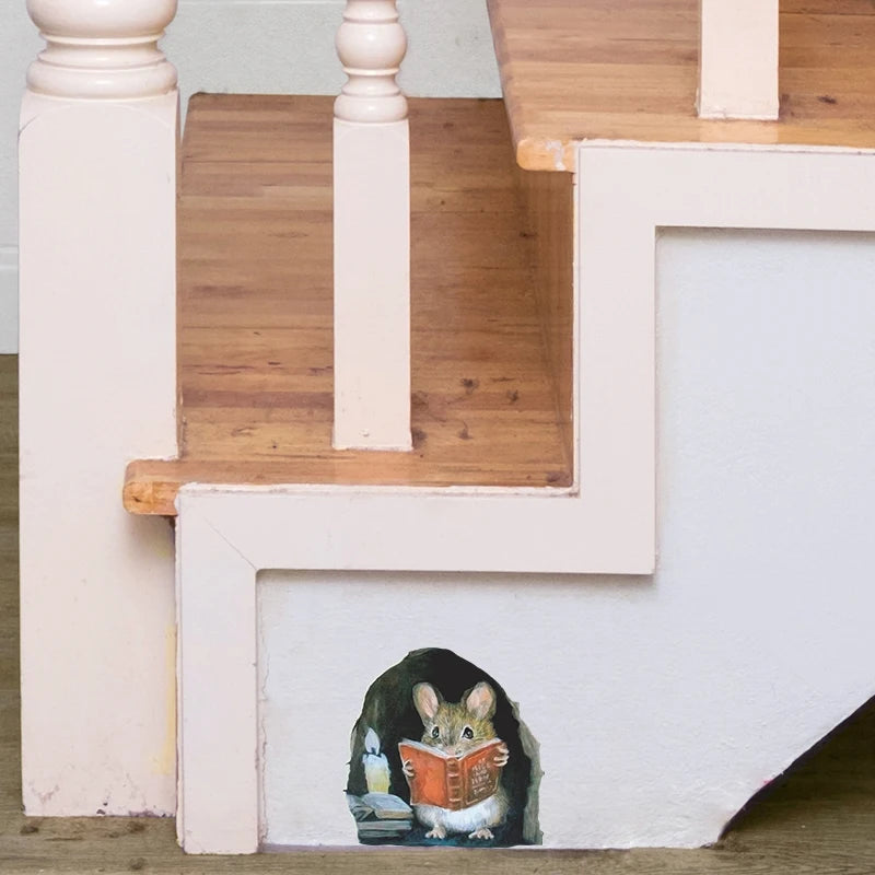 A cartoon mouse is sitting on the bottom step of a wooden staircase, reading a book against a white wall.
