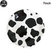 A white plate decorated with black cow print spots, suitable for farm-themed parties.