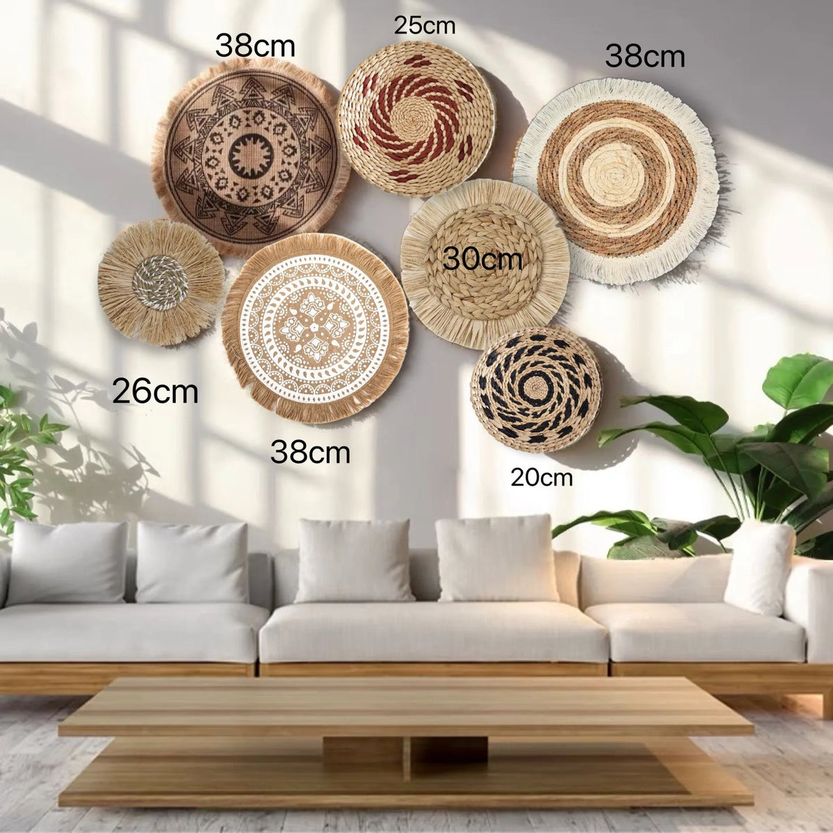 A collection of round boho straw wall hangings with varying diameters and textures displayed on a light gray wall.
