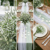 A close-up of white baby's breath flowers arranged in a lush green and white floral display.