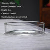 A clear glass bowl or vase is shown on a gray fabric, with specifications listed nearby.