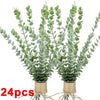A bundle of artificial eucalyptus stems with green leaves tied together for home decor or wedding centerpieces.