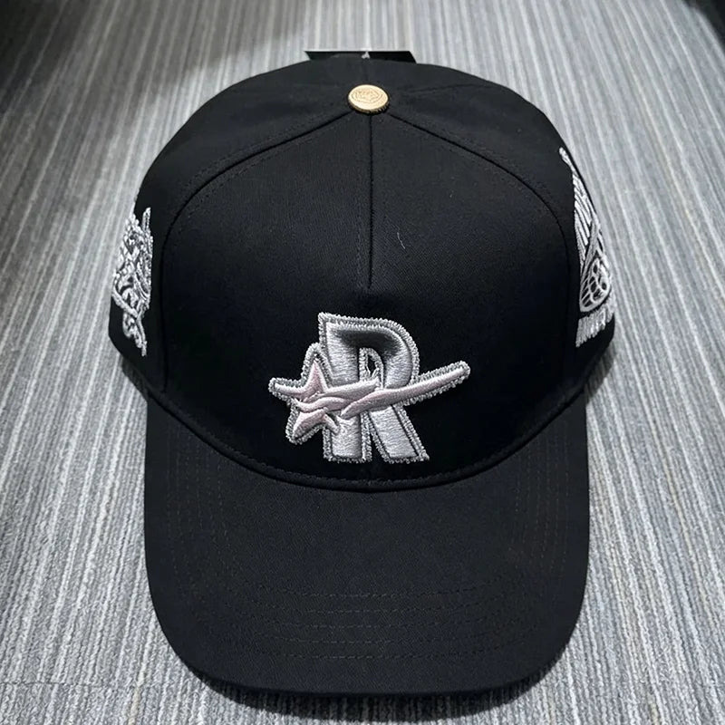 Black embroidered star hip-hop baseball cap with silver detailing and a gold button.