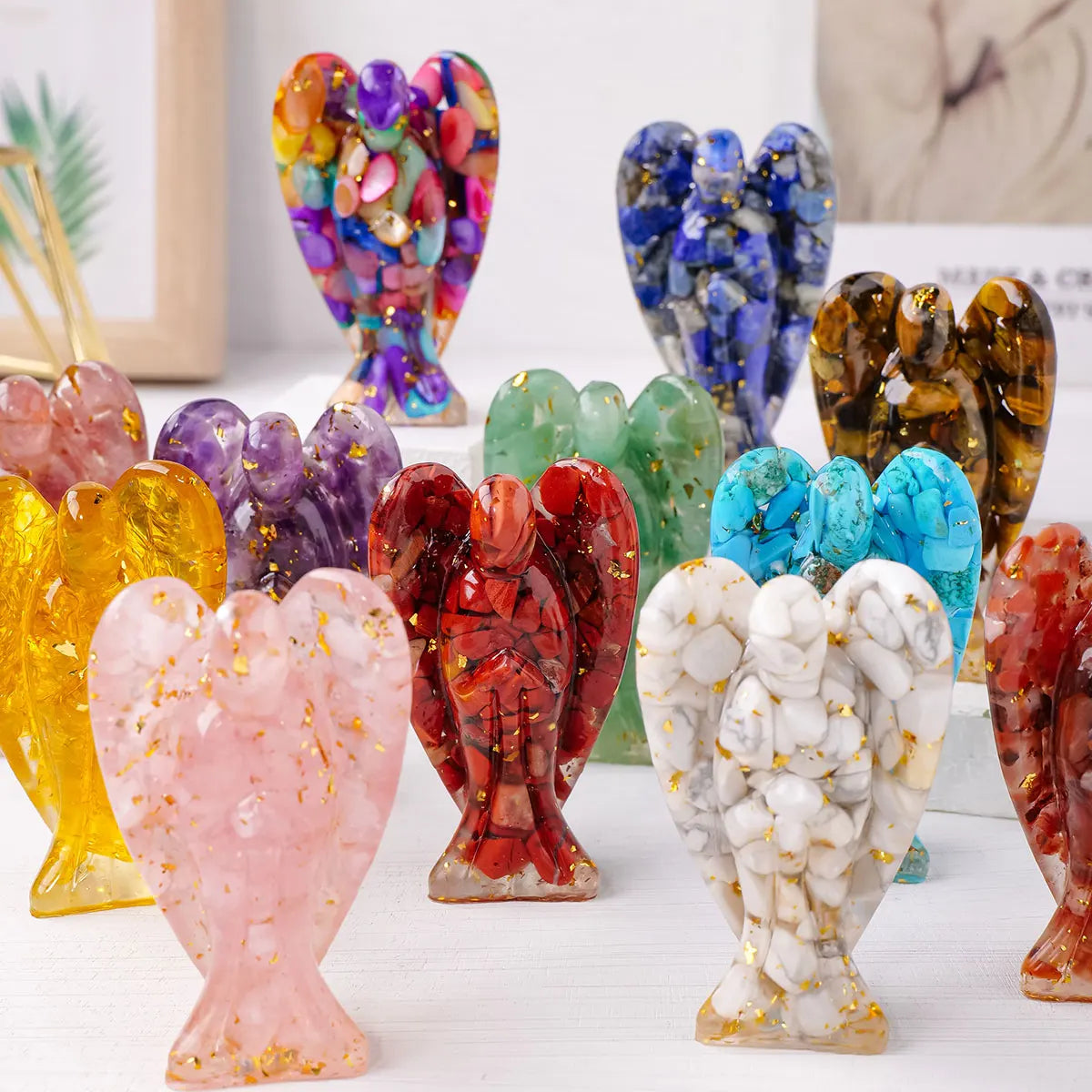 A collection of natural crystal guardian angel figurines in various colors and shapes.
