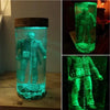 A collectible lamp featuring a figure resembling Jason Voorhees submerged in glowing green liquid inside a glass container.