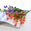 A bundle of purple and orange artificial flowers used for home and event decoration.