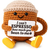 Handwoven knitted coffee cup cozy shaped like a smiling brown doll with yellow accents