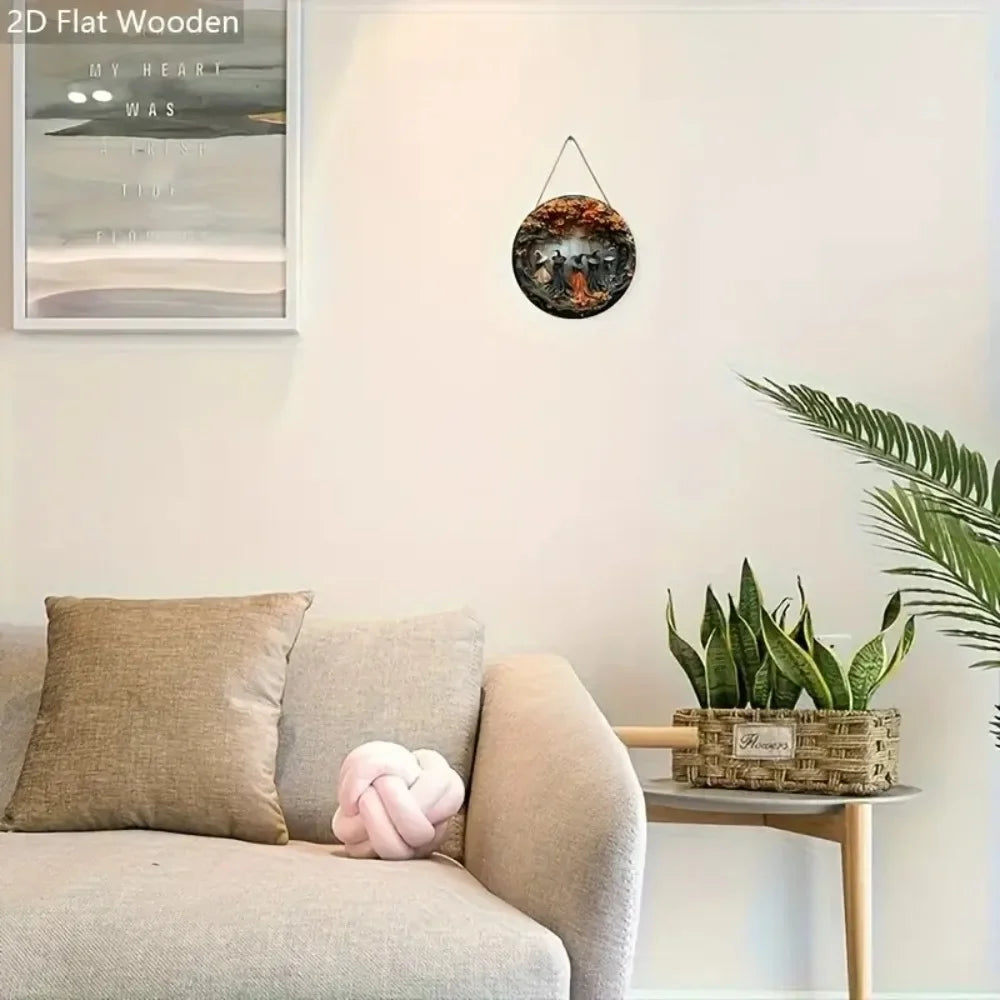 A wooden circular decor sign featuring a witch and autumn leaves hanging on a white wall.
