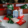 A festive advent calendar box filled with themed books and ornaments, set against a wooden background.