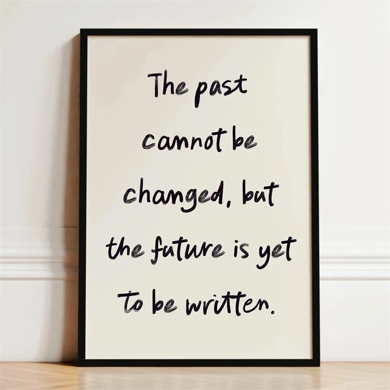 A framed print with black text on a white background that reads The past cannot be changed, but the future is yet to be writt