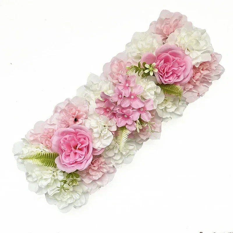 A floral arrangement of pink and white artificial silk roses and hydrangeas for weddings and events.