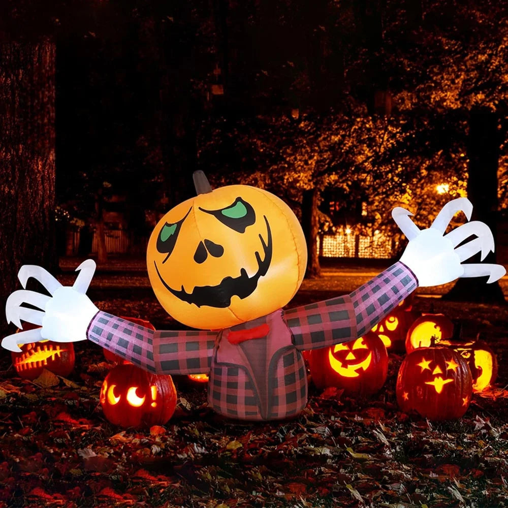 An inflatable orange pumpkin decoration with white arms and a carved face sits on the ground in a dark outdoor setting.
