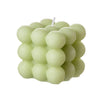 A set of two soy wax candles, one white and one pink, shaped like cubes.