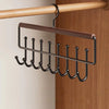 A wall-mounted metal coat rack with a wooden bar and eight hooks is displayed on a wooden panel.