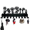 Black decorative metal key hooks with floral silhouette design for wall organization