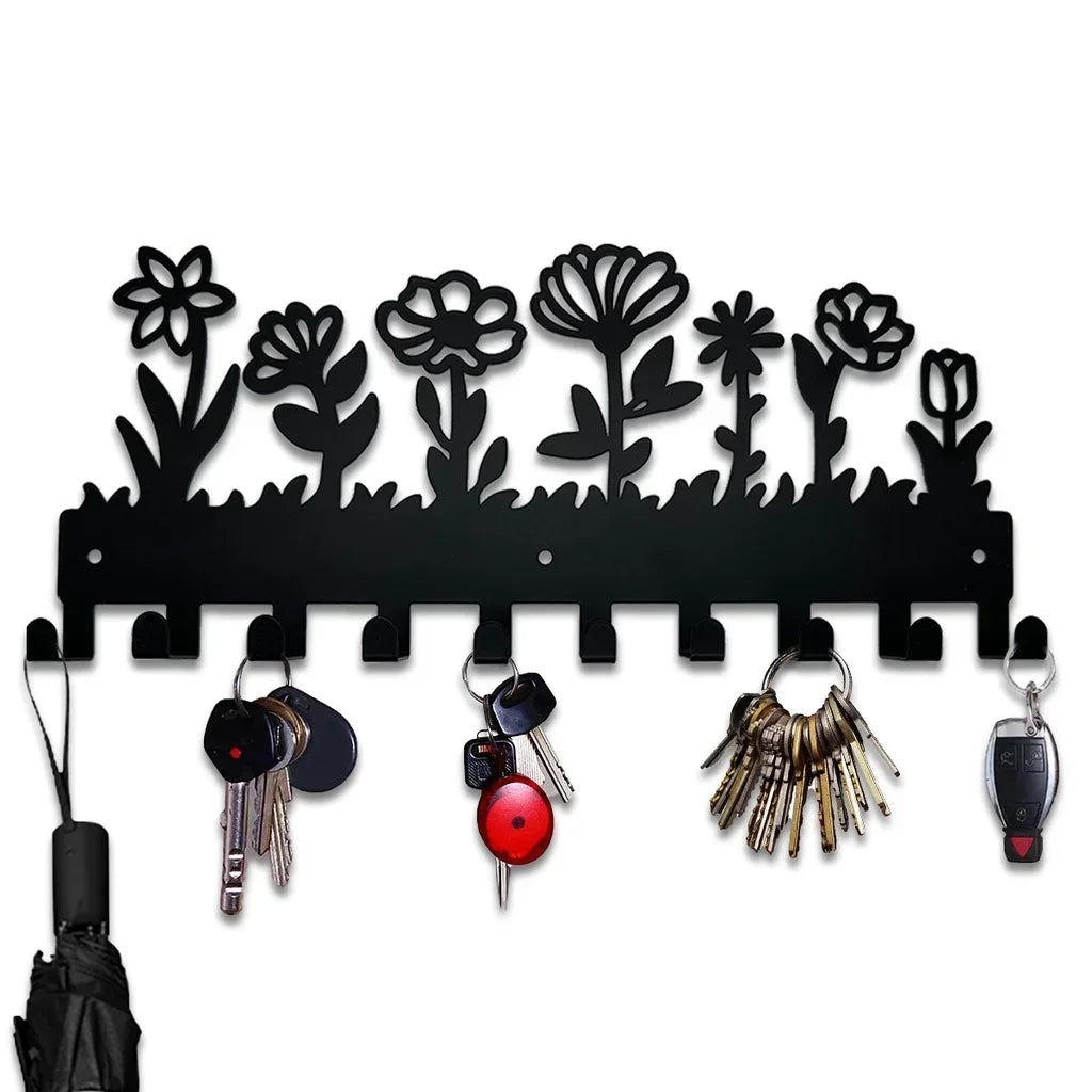 Black decorative metal key hooks with floral silhouette design for wall organization