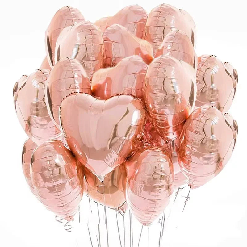 A bunch of pink heart-shaped foil balloons tied together with strings.