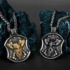 A silver stainless steel necklace featuring a Viking warrior shield pendant hanging from a chain against a dark blue rock.