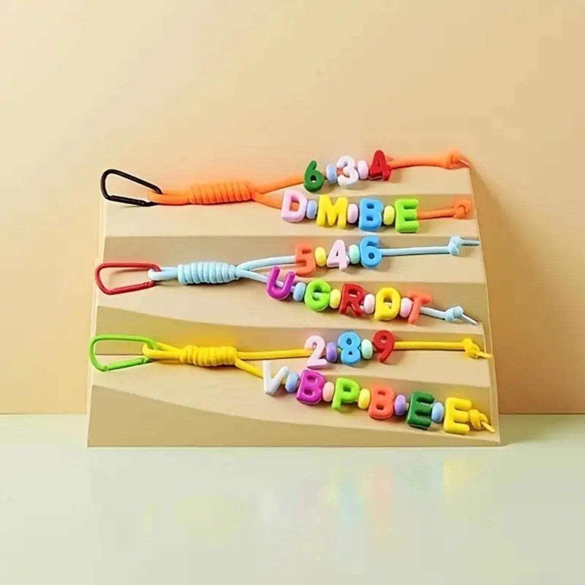 A set of colorful nylon rope craft kits with numbers and letters for DIY keychains and charms.