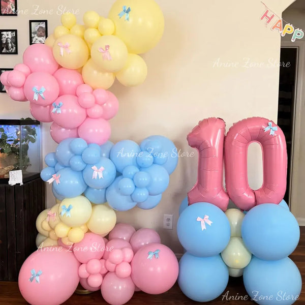 A collection of pastel pink and blue latex balloons for party decorations