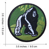 An embroidered patch depicting a black and white Bigfoot figure on a green background.
