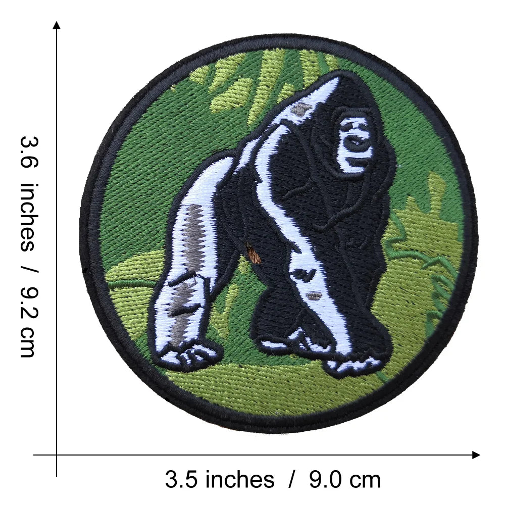 An embroidered patch depicting a black and white Bigfoot figure on a green background.