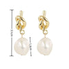 Elegant gold bean spliced pearl drop earrings with a twisted link and a round pearl drop.