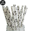A bundle of white and black football-themed paper straws or sticks in a glass container.