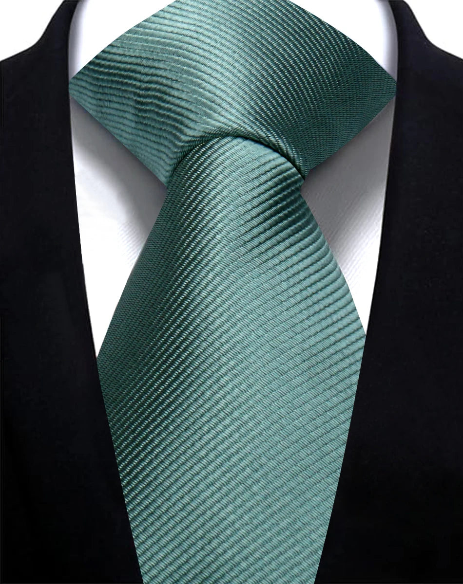 A teal striped silk necktie tied in a knot against a black suit jacket.