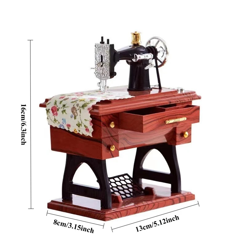 A wooden retro miniature sewing machine with a metal body and a crank, displayed on a base.