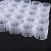 A collection of clear plastic balloon arch connector rings for party decor arranged in rows.