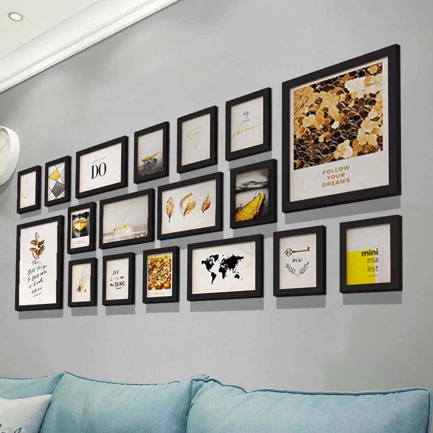 A gallery wall display featuring multiple framed pictures with nature and inspirational quotes on a gray wall.