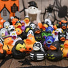 A collection of black and white rubber ducks in various colors, including orange, yellow, purple, and blue, displayed on a bl