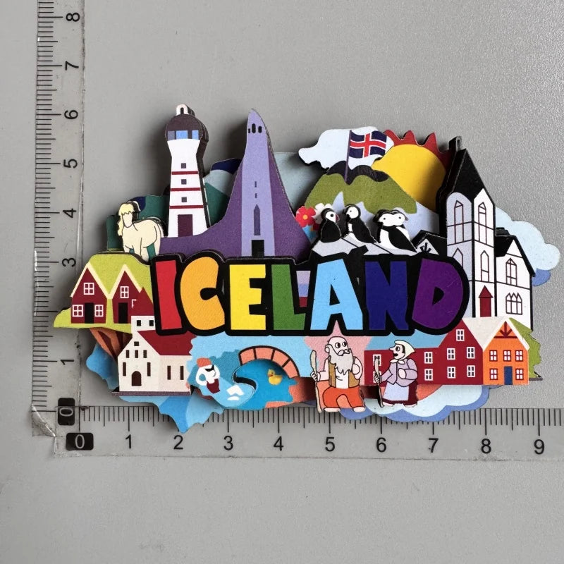 A collection of wooden fridge magnets featuring various Icelandic landmarks, including a lighthouse and wildlife.