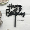 Black acrylic birthday cake topper with the words Happy Birthday on a stick