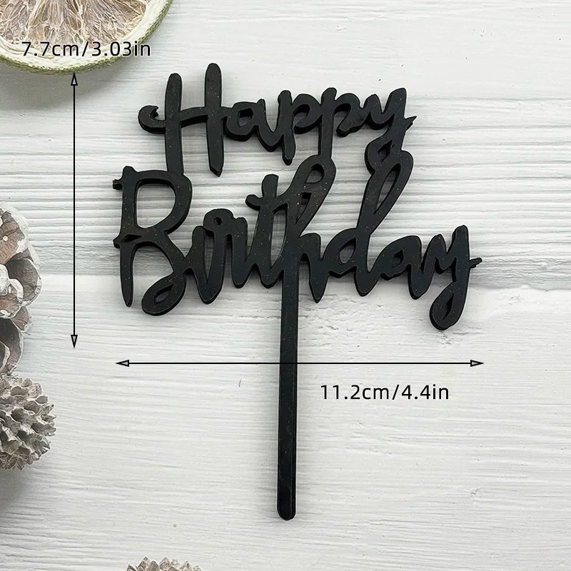 Black acrylic birthday cake topper with the words Happy Birthday on a stick