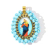 A gold-toned pendant featuring a framed image of the Virgin Mary and a cluster of light blue beads.