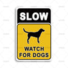 A yellow and black warning sign with the text SLOW WATCH FOR DOGS and a silhouette of a dog.