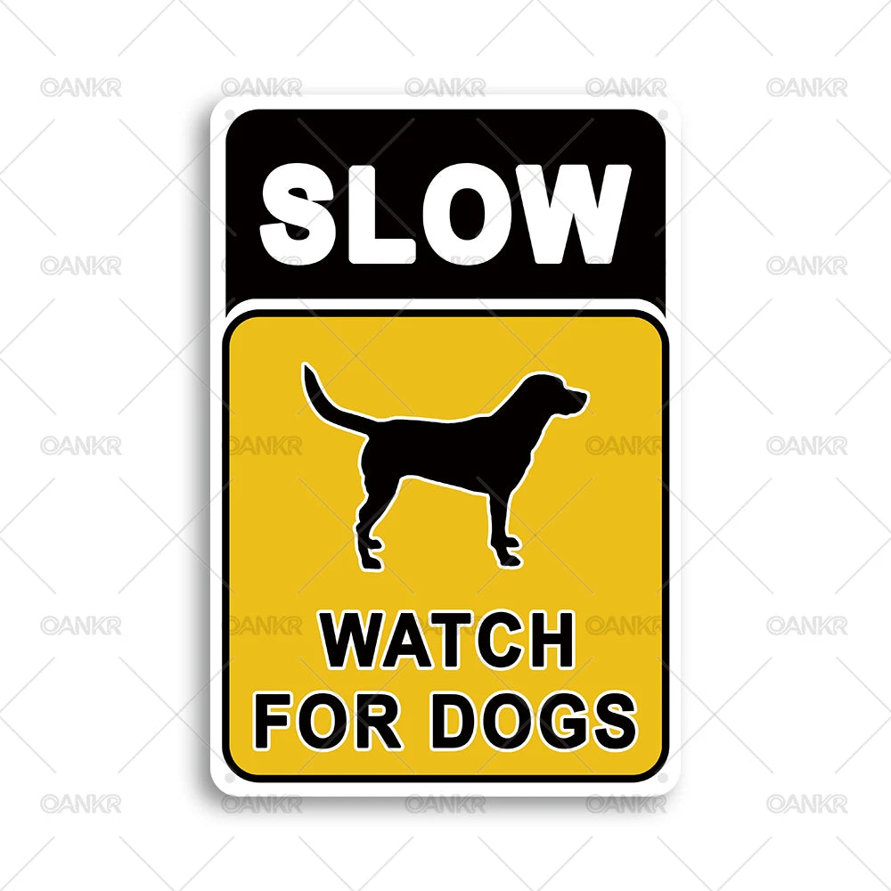 A yellow and black warning sign with the text SLOW WATCH FOR DOGS and a silhouette of a dog.