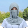 A person wearing a light gray breathable UV protection balaclava face mask and long neck cover outdoors.