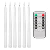 A set of six white flameless taper candles and a remote control with timer and light settings.