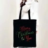 Black tote bag with pink and green script text that reads Merry Christmas to you