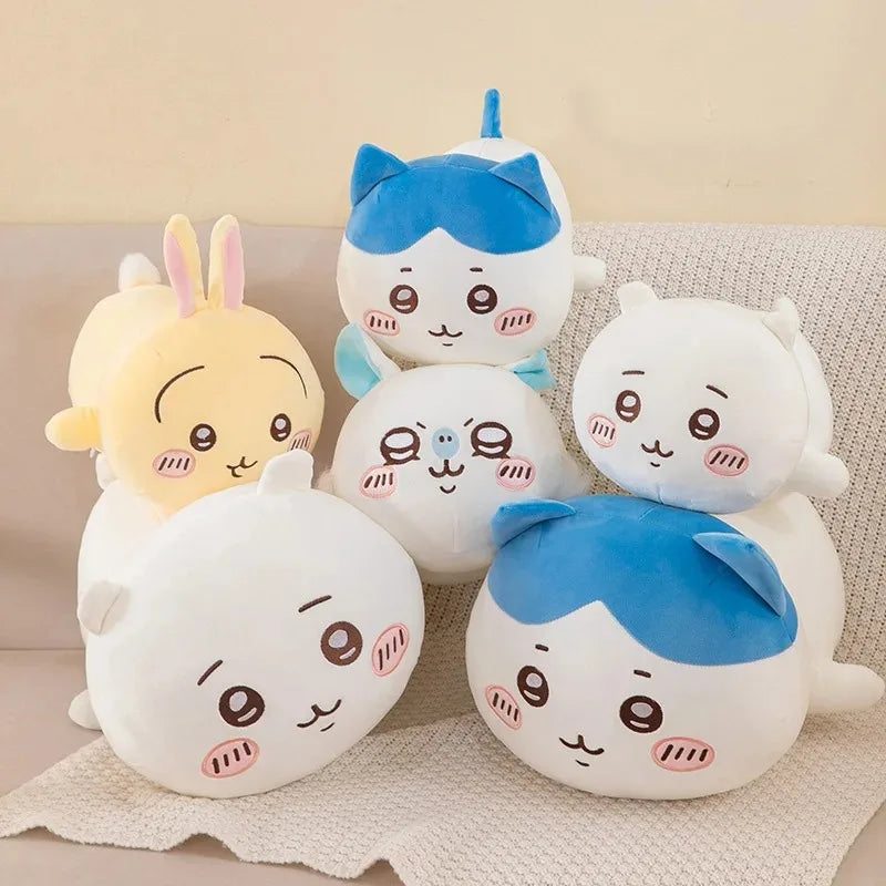 A collection of soft anime plush pillows featuring blue and white characters like Hachiware.