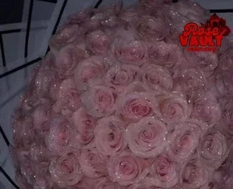 A close-up of a large bouquet of pink glitter artificial roses.
