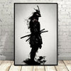 Black and white canvas wall art depicting a silhouette of a samurai with a helmet and sword against a bright background.