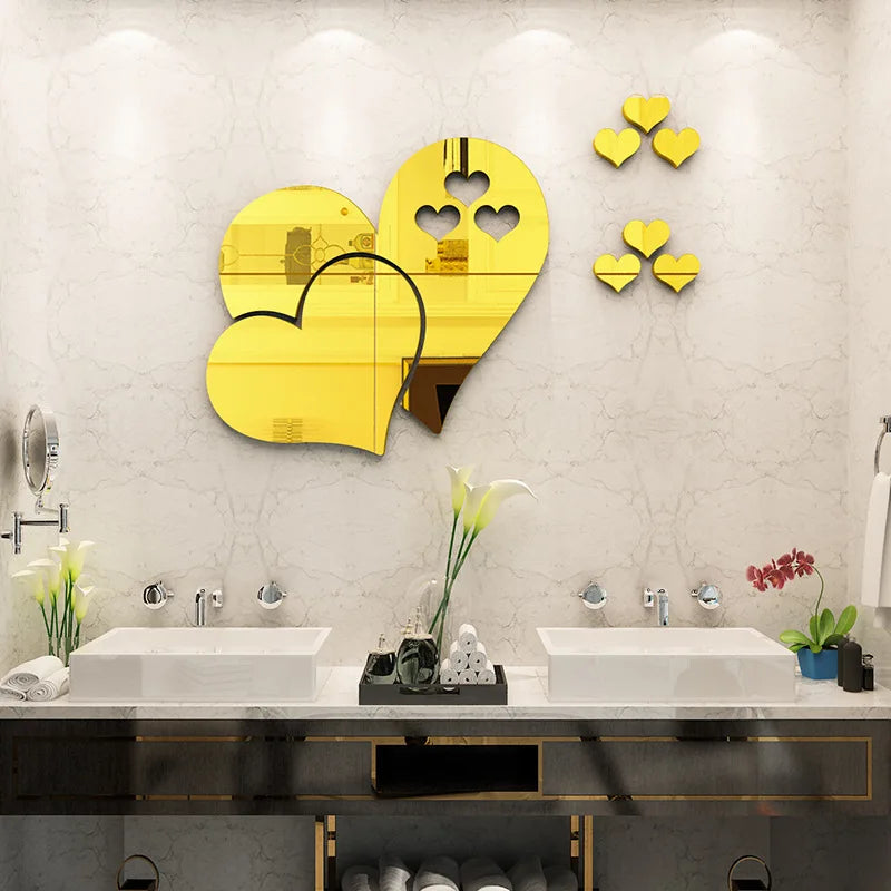 Elegant gold acrylic heart wall art decals displayed on a white bathroom wall.