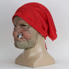 A realistic latex horror mask of an elderly woman with wrinkled skin wearing a bright red headscarf.