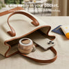 A beige leather handbag with a pocket holding a small, round magnetic bladeless handheld fan.