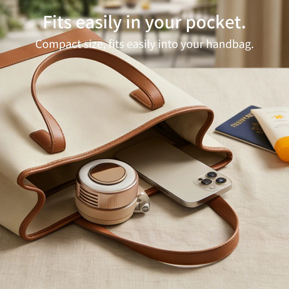 A beige leather handbag with a pocket holding a small, round magnetic bladeless handheld fan.
